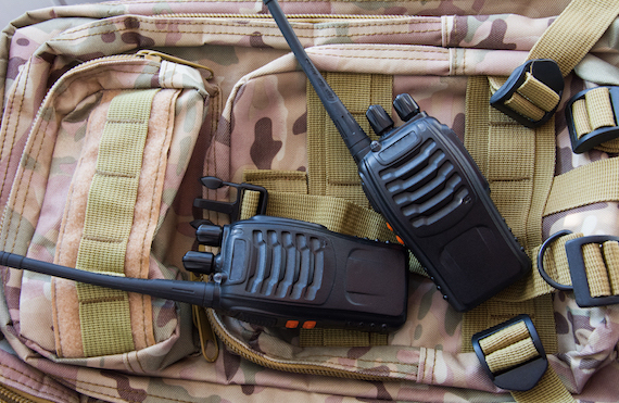 Pair Of Portable Radio Sets On The Background Of A Military Backpack Camouflage Modern Army Radio
