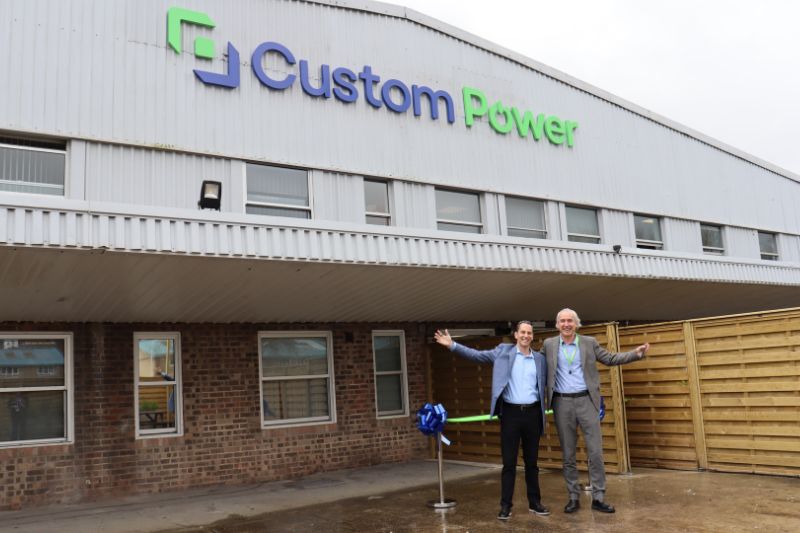 Two people standing in front of Custom Power UK