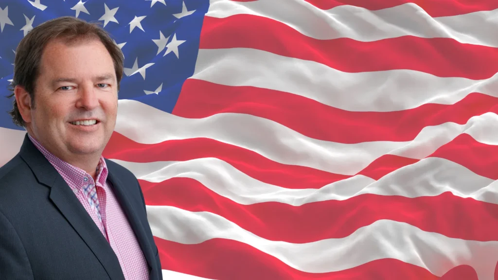 New CSO standing in front of the US stars and stripes flag