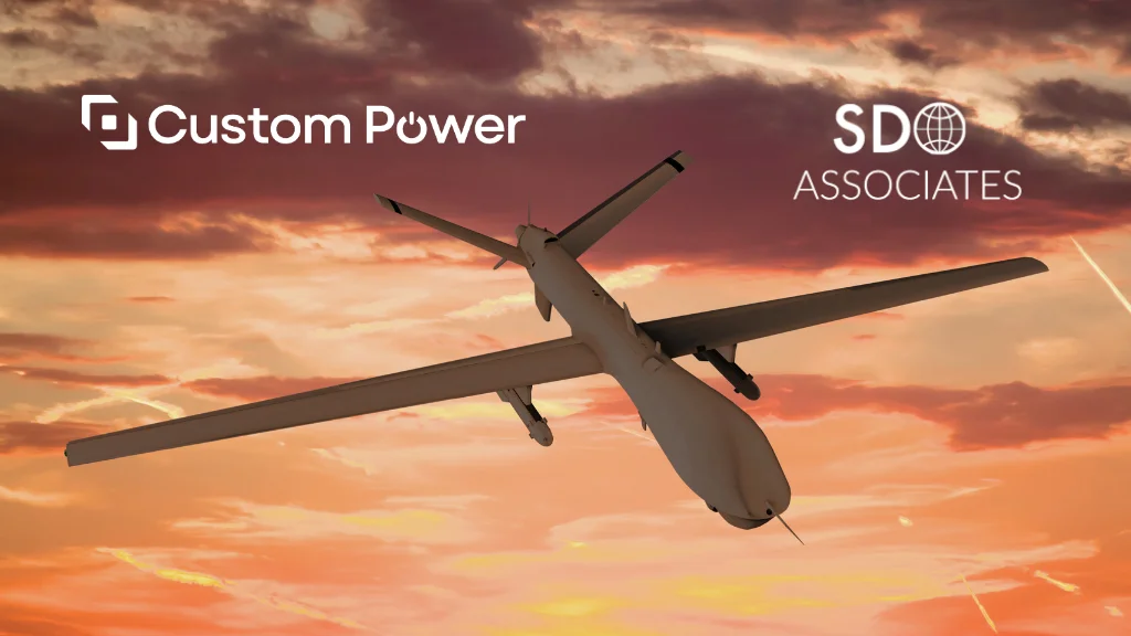 Drone against a sunset with Custom Power and SDO Associates logos